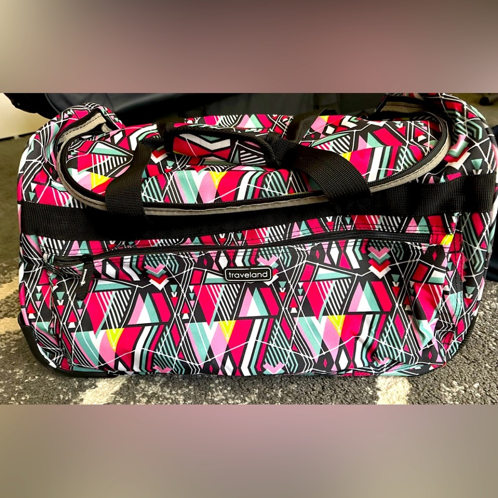 Traveland suitcase on wheels w/handle.New never used. Fun pattern 20"x12"x10"